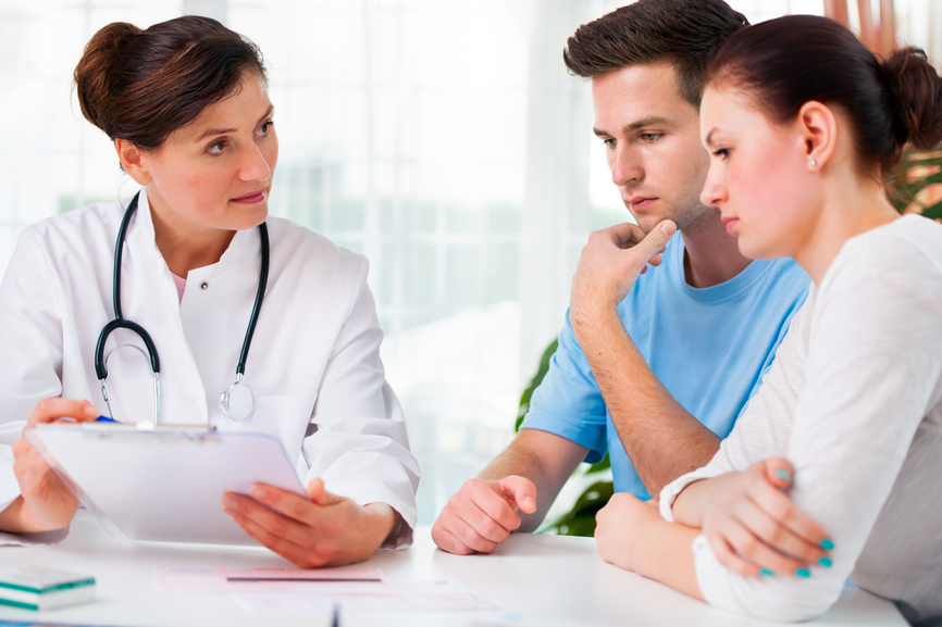 Couple talking to doctor about pregnancy