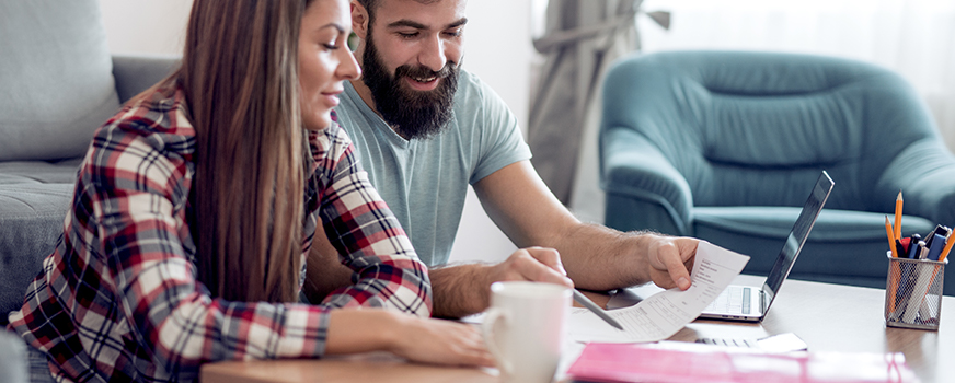 Couple Updating Health Insurance for Baby Financial Planning