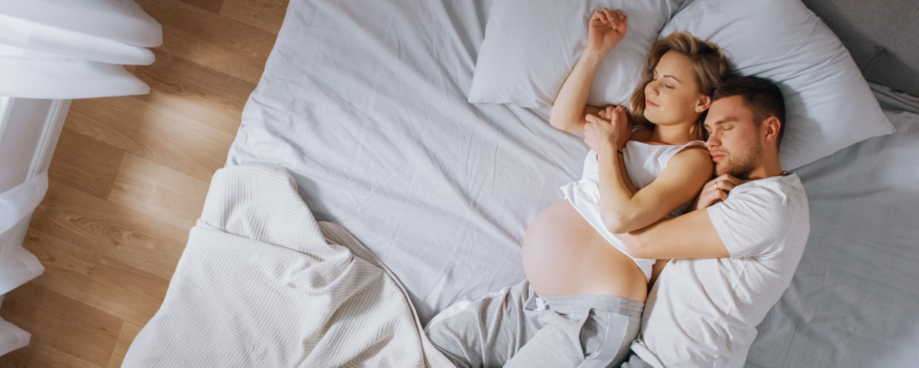 Expecting Couple Sleeping on Side to Help Induce Labor