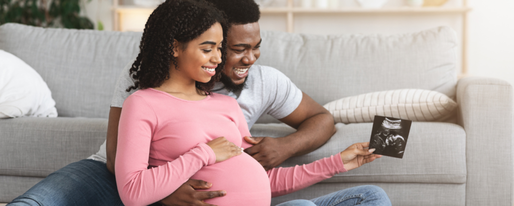 Happy Couple Looking at Pregnancy Progress on Ultrasound