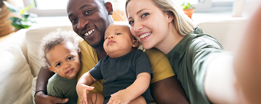 Happy Parents with Two Children Taking Selfie