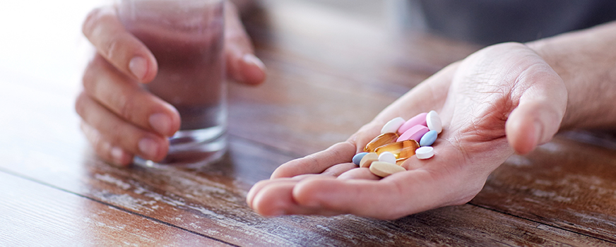 Man Holding Vitamins for Fertility