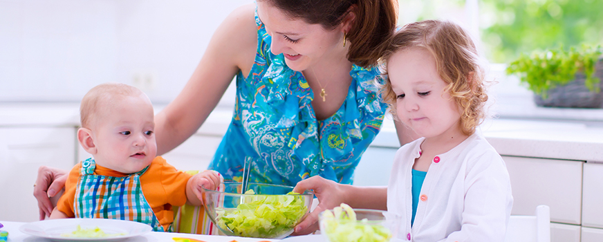 Mother Preparing Food for Two Children