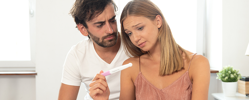 Couple Looking at Negative Pregnancy Test