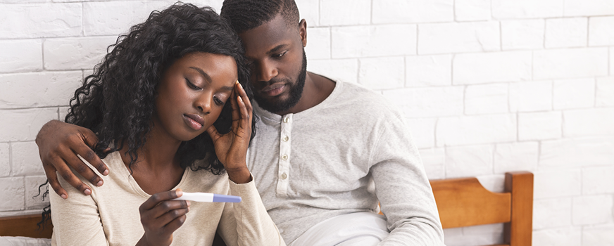 Infertile Couple Looking at Failed Pregnancy Test