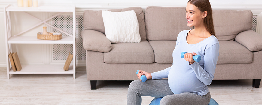 Woman Exercising During Pregnancy with Weights