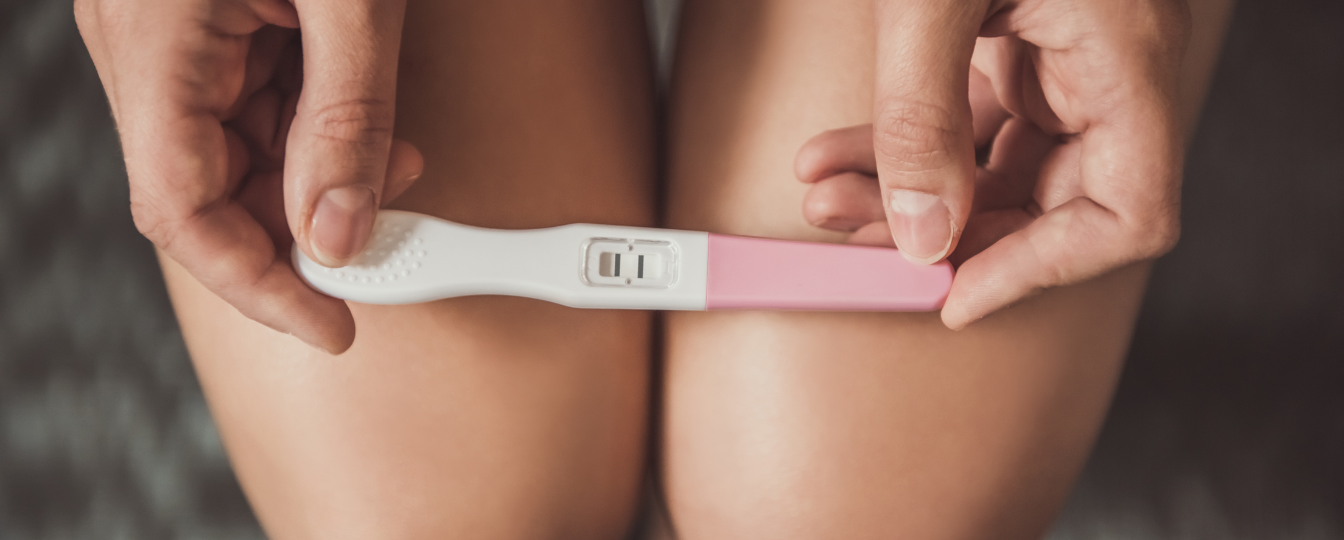 Woman Holding Positive Pregnancy Test