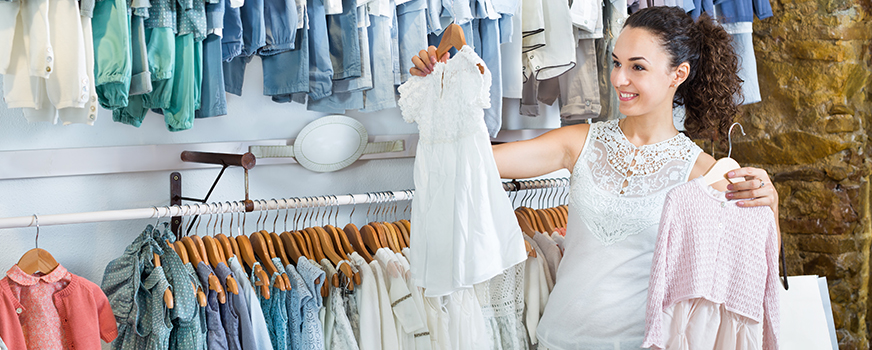 Woman Shopping for Baby Clothes at Store