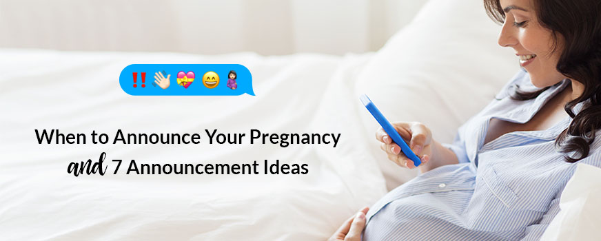 Woman sitting in bed, sending a text to her friends about her pregnancy