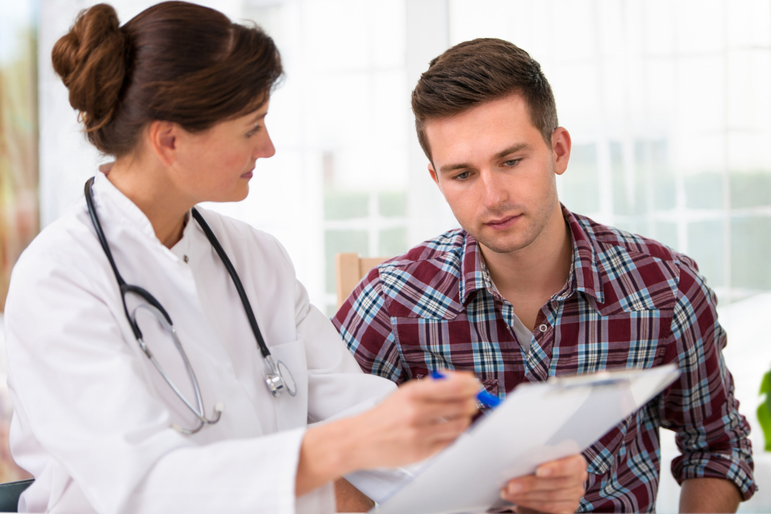 doctor showing fertility results to male patient